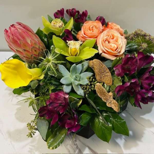 Mixed bouquet with protea, roses, calla lilies, and succulents