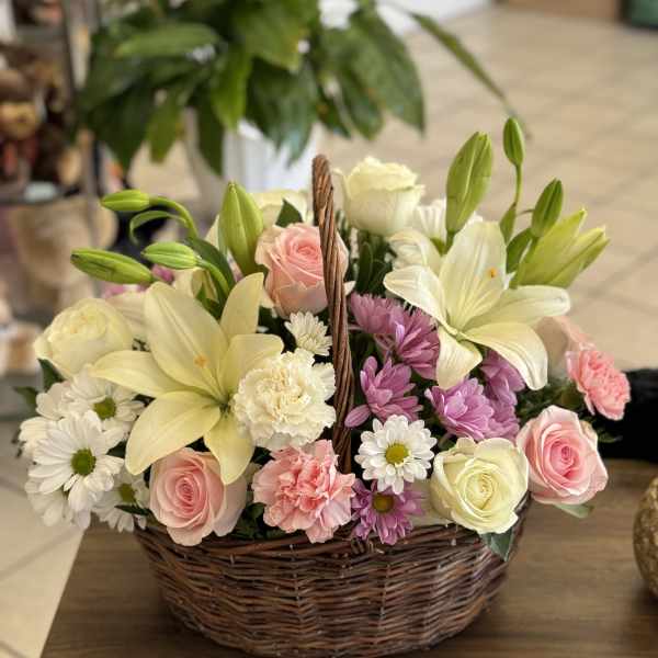 White and pink florals in wicker basket