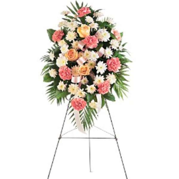 Standing floral spray with pink and white flowers on an easel