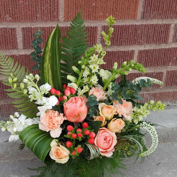 Mixed bouquet with peach roses, white blooms, and greenery