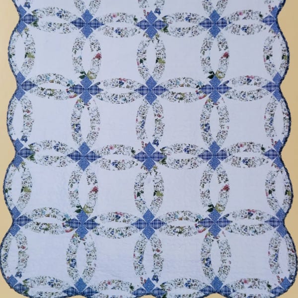 Blue and white quilt with floral ring patterns