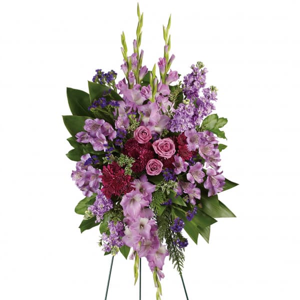 Tall purple floral standing spray on a wire easel