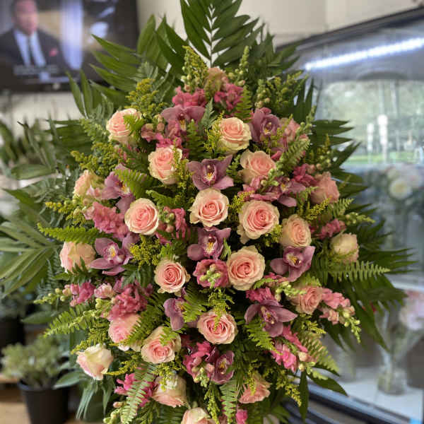 Large standing spray of pink roses and purple orchids