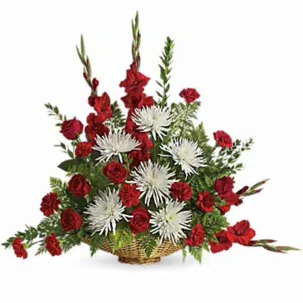 Red and white floral arrangement in a wicker basket