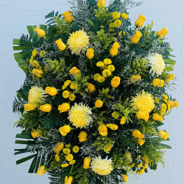 Large yellow floral standing spray with roses and chrysanthemums