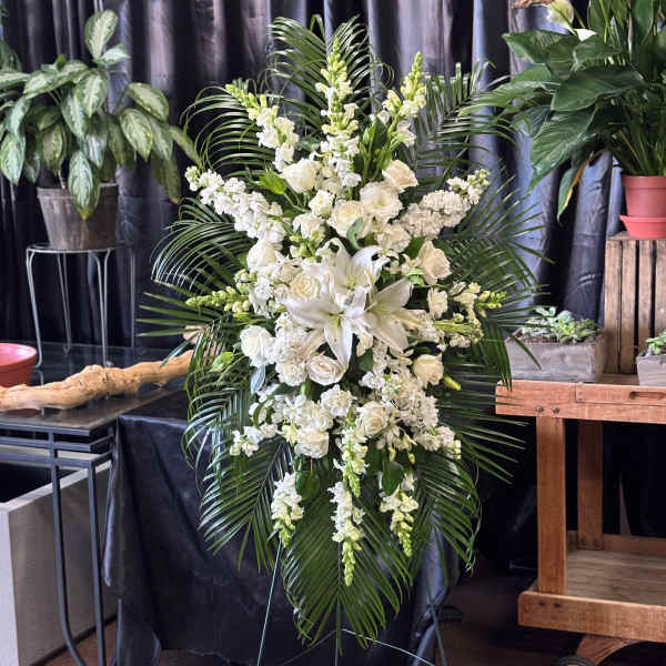 Tall white floral standing spray with lilies and roses