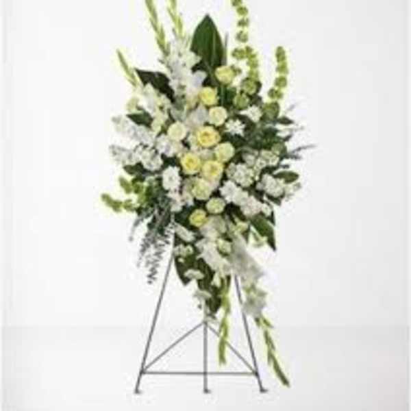Tall white and green floral standing spray on an easel