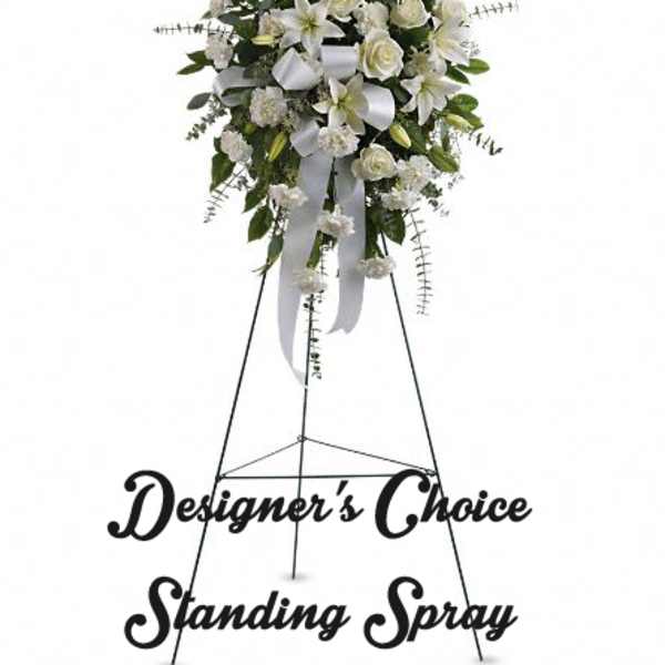 White standing floral spray on a metal easel with ribbon