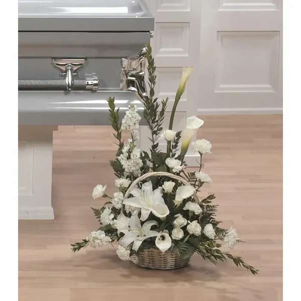 White floral basket arrangement with lilies and calla lilies