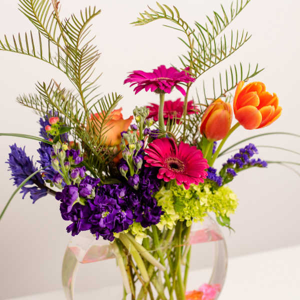 Colorful mixed bouquet in a clear round vase