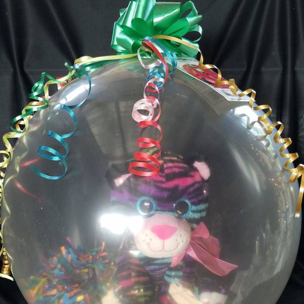 Clear balloon with a plush tiger and colorful curling ribbons