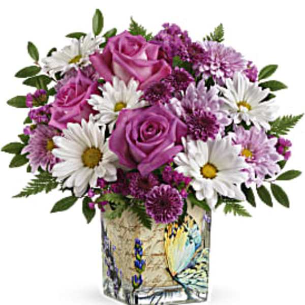Pink roses and white daisies in a decorative square vase