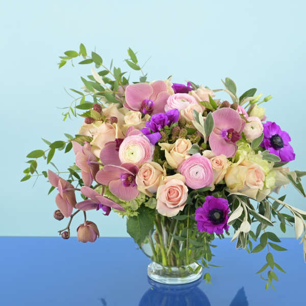 Pink and purple mixed bouquet in a clear glass vase