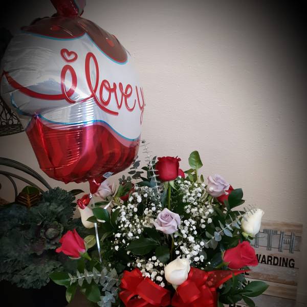 Bouquet of red and white roses with a heart balloon