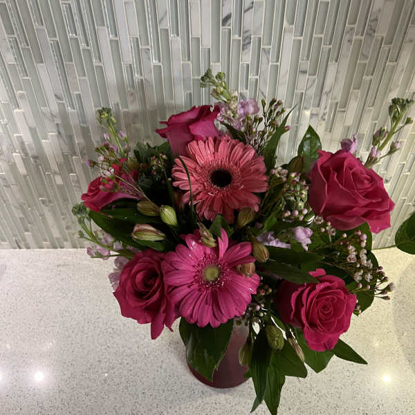 Pink roses and gerbera daisies in a vase