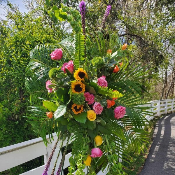 Large tropical floral standing spray with roses and sunflowers