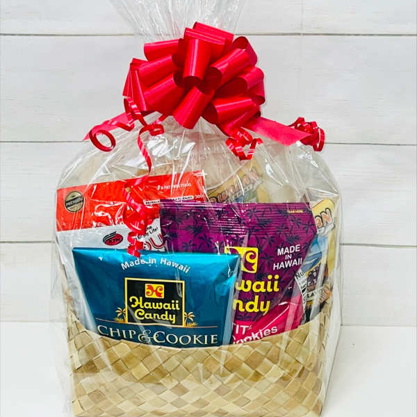 Assorted Hawaiian snacks in a woven gift basket wrapped in cellophane with a red bow