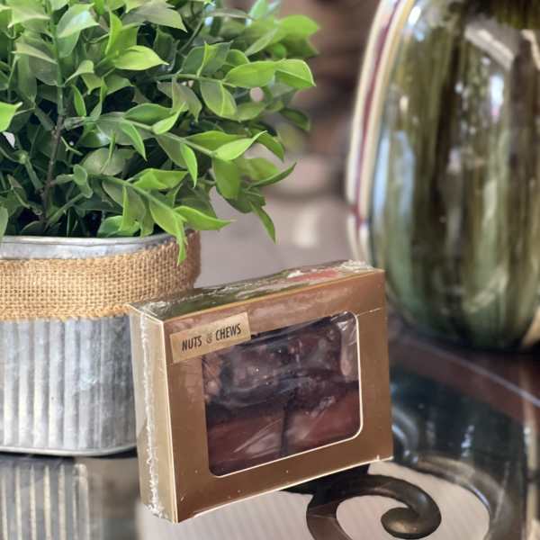 Potted green plant beside a box of nuts and chews