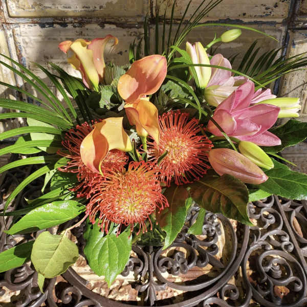 Bouquet with pink calla lilies and orange pincushion blooms