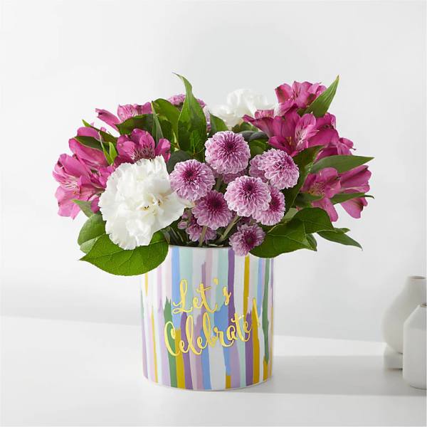 Pink and white flowers in a striped vase with "Let's Celebrate" text