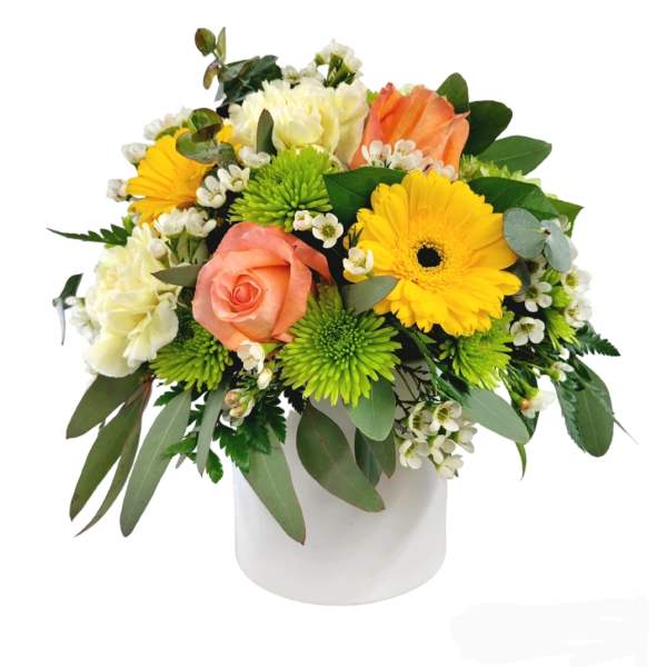 Mixed bouquet in a white vase with yellow, peach, and white flowers
