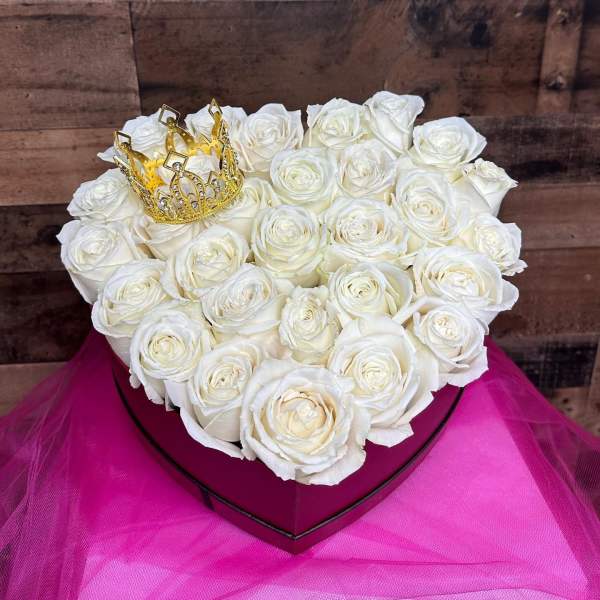 Heart-shaped box of white roses with a gold crown topper