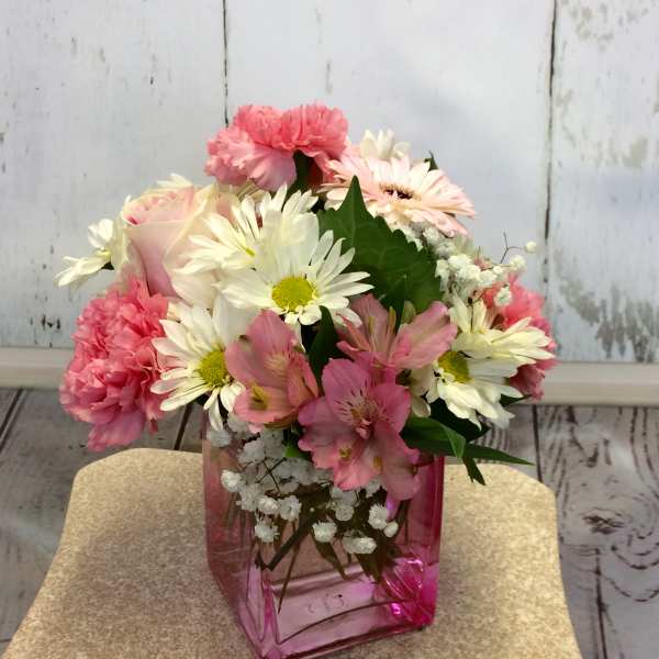 Pink and white mixed bouquet in a pink glass vase
