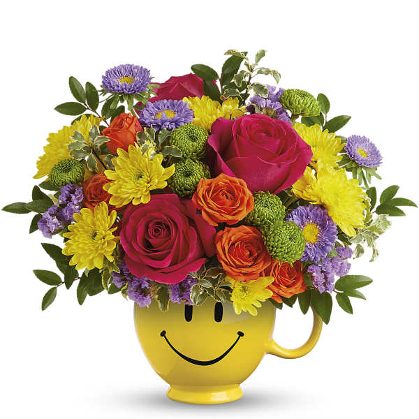 Mixed bouquet in a yellow smiley-face mug