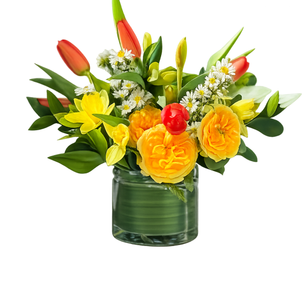 Yellow and orange flowers arranged in a clear glass vase