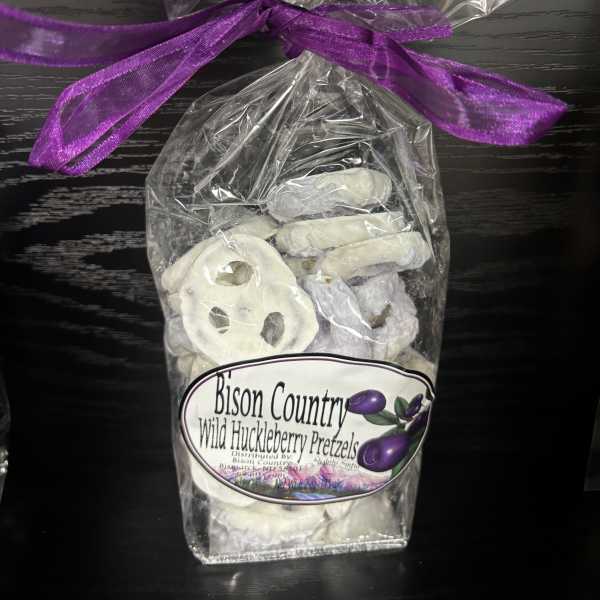 Bag of white chocolate-covered pretzels tied with a purple ribbon