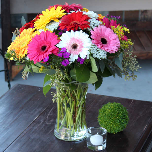 Colorful gerbera daisy bouquet in a clear glass vase
