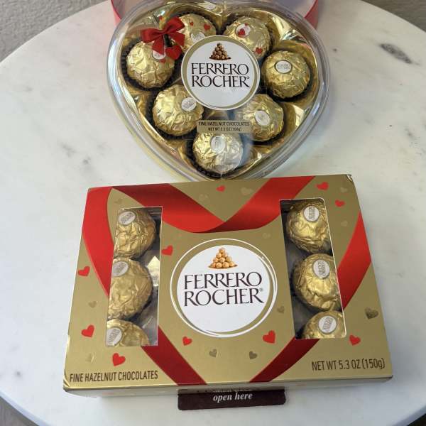 Heart-shaped boxes of Ferrero Rocher chocolates on a table