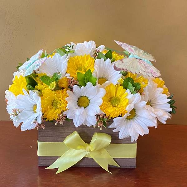 Yellow and white daisy bouquet in a wooden box with a ribbon