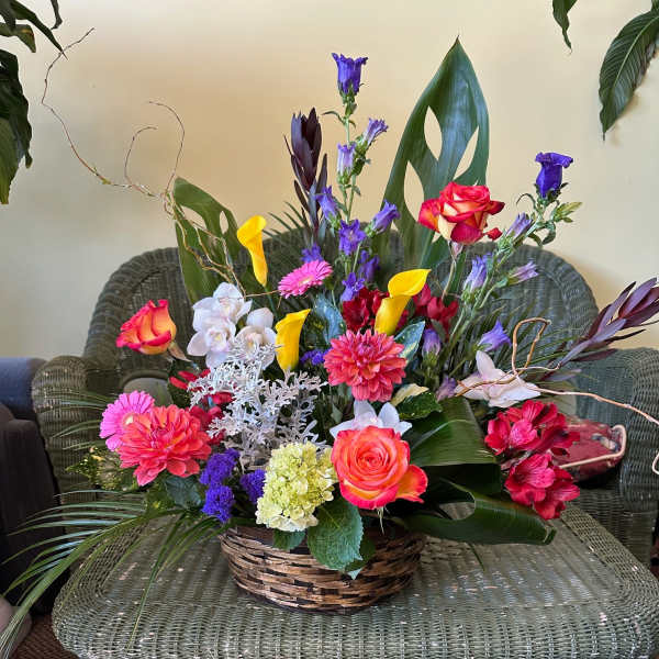 Colorful mixed flower arrangement in a wicker basket