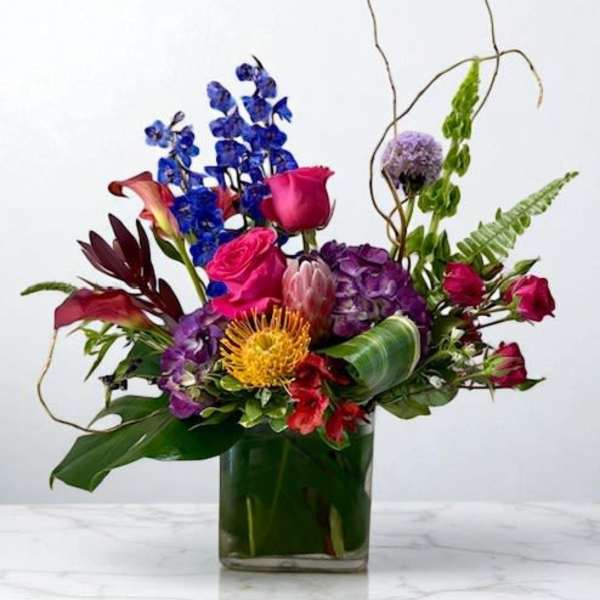 Colorful mixed flower arrangement in a glass vase
