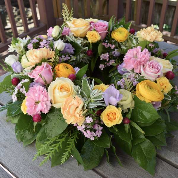 Colorful floral wreath with roses, carnations, and small filler flowers