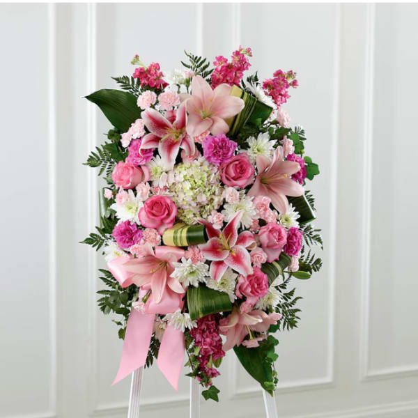 Pink and white floral standing spray with lilies and roses on an easel