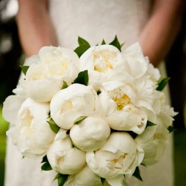White bridal bouquet of peonies with green accents
