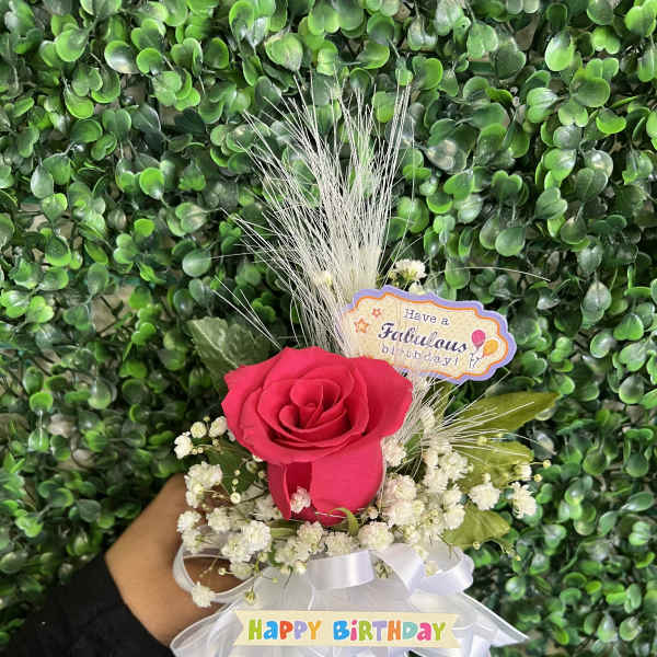 Pink rose bouquet with white baby's breath and birthday ribbons