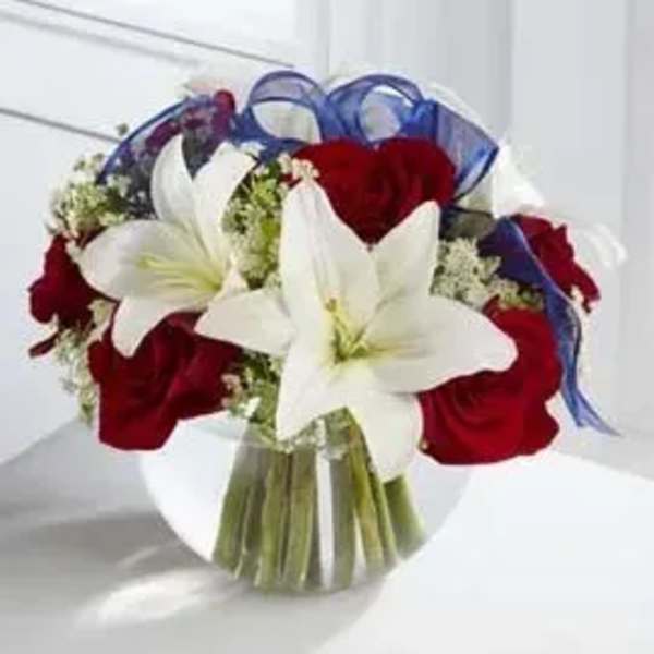 Bouquet of red roses and white lilies with blue ribbon wrap