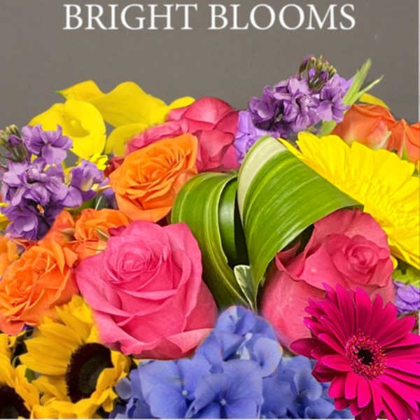 Bright mixed bouquet with roses, calla lilies, sunflowers, and purple blooms