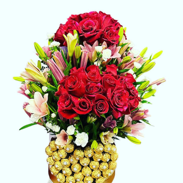 Red rose bouquet with pink lilies and Ferrero Rocher chocolates in a decorative container