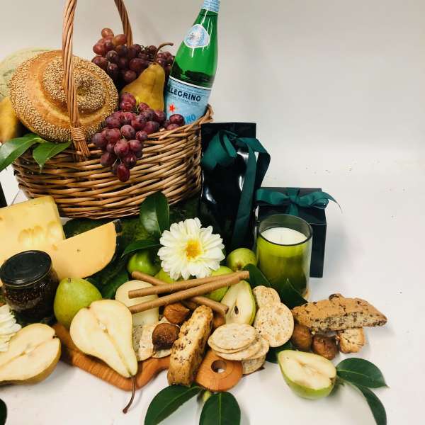 Gift basket with fruit, bread, cheese, crackers, and a candle