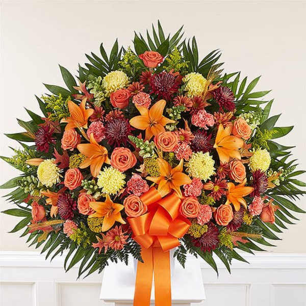 Large orange and coral floral spray with lilies and roses
