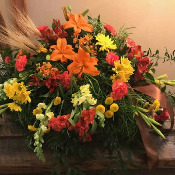 Colorful floral arrangement with orange lilies and yellow daisies