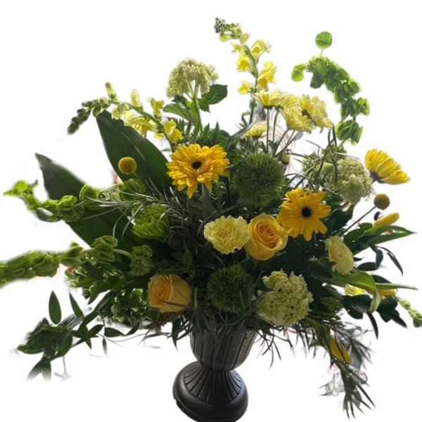 Yellow and green floral arrangement in a dark urn vase
