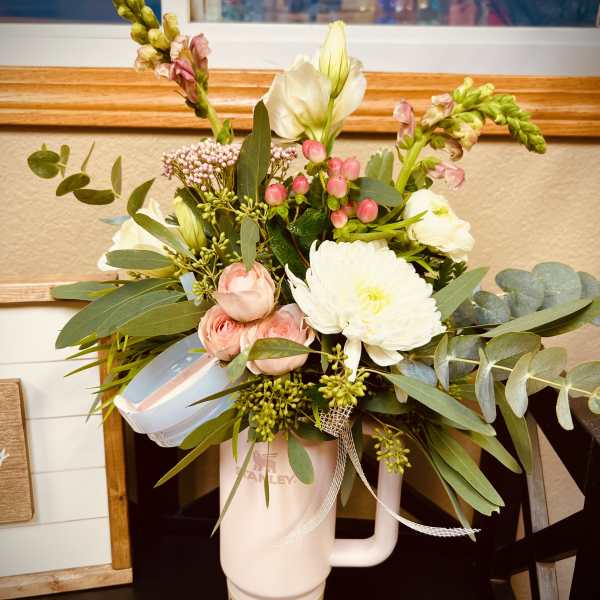 Mixed bouquet in a pink tumbler with white and pink flowers