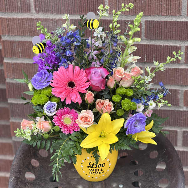 Colorful mixed bouquet in a yellow bee-themed vase
