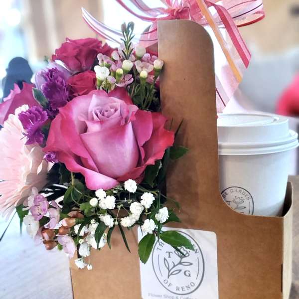 Pink rose bouquet in a kraft gift box with a ribbon and coffee cup
