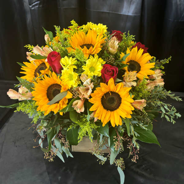 Sunflower and red rose arrangement in a wooden box